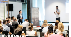 Male business speaker giving a talk at business conference event.